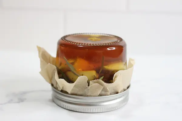 upside down sealed mason jar of homemade herb infused honey