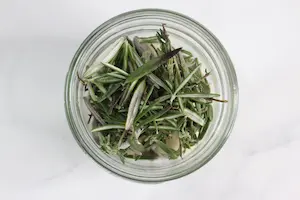 jar of herbs for making infused honey