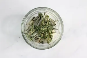 jar of herbs for making infused honey