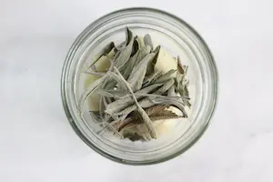 jar of herbs for making infused honey