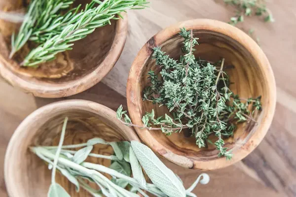 wooden bowls of herbs to use in infused honey