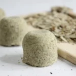 homemade eucalyptus shower steamers with dried eucalyptus on wood