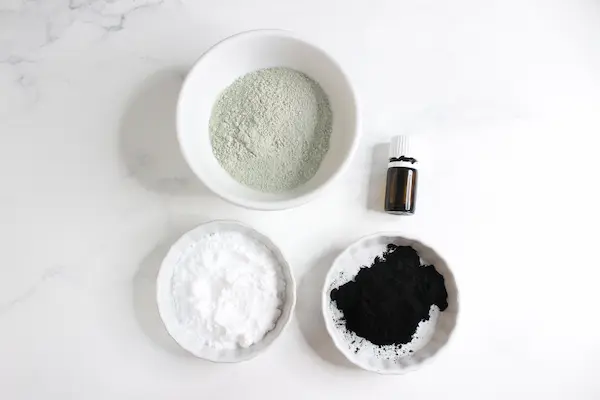 bowls of ingredients for making homemade armpit detox powder