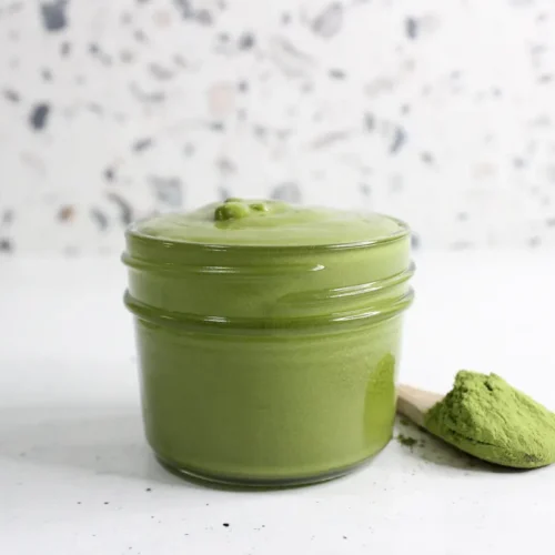 clear glass jar of homemade green tea face cream
