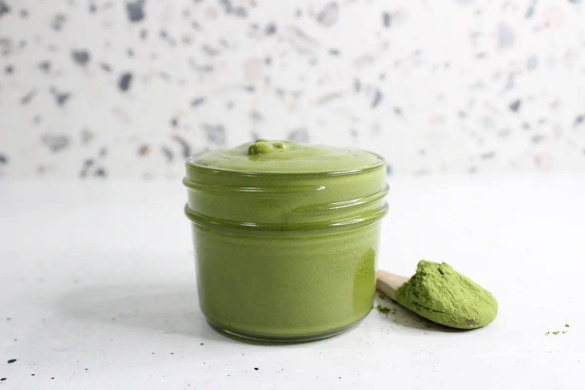 clear glass jar of homemade green tea face cream