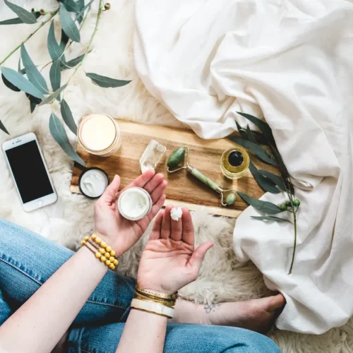 a woman's legs and hands surround by natural self care products