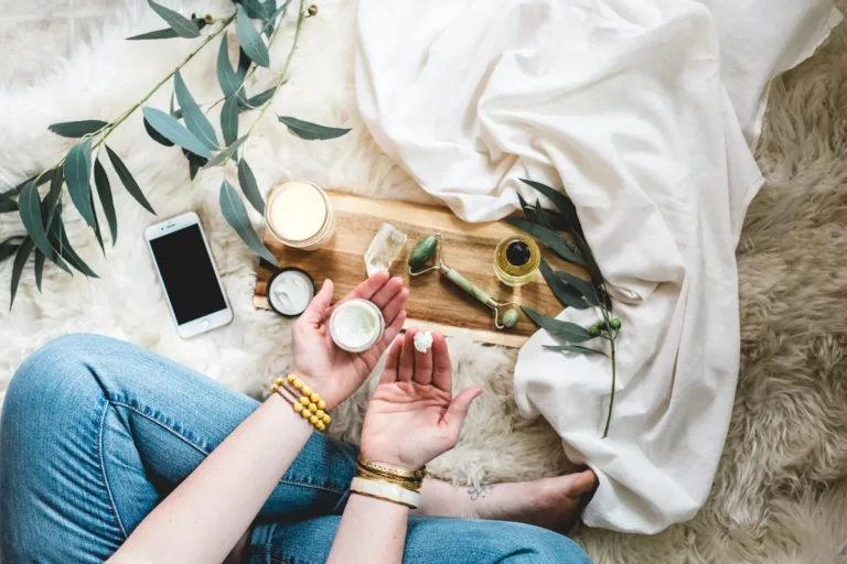 a woman's legs and hands surround by natural self care products