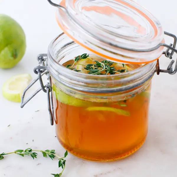 Thyme Cough Syrup With Honey Lemon & Ginger DIY Recipe 16 a jar with a lid of homemade thyme, ginger, lemon and honey cough syrup