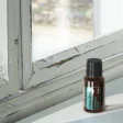 bottle of doterra costa brio on rustic window ledge