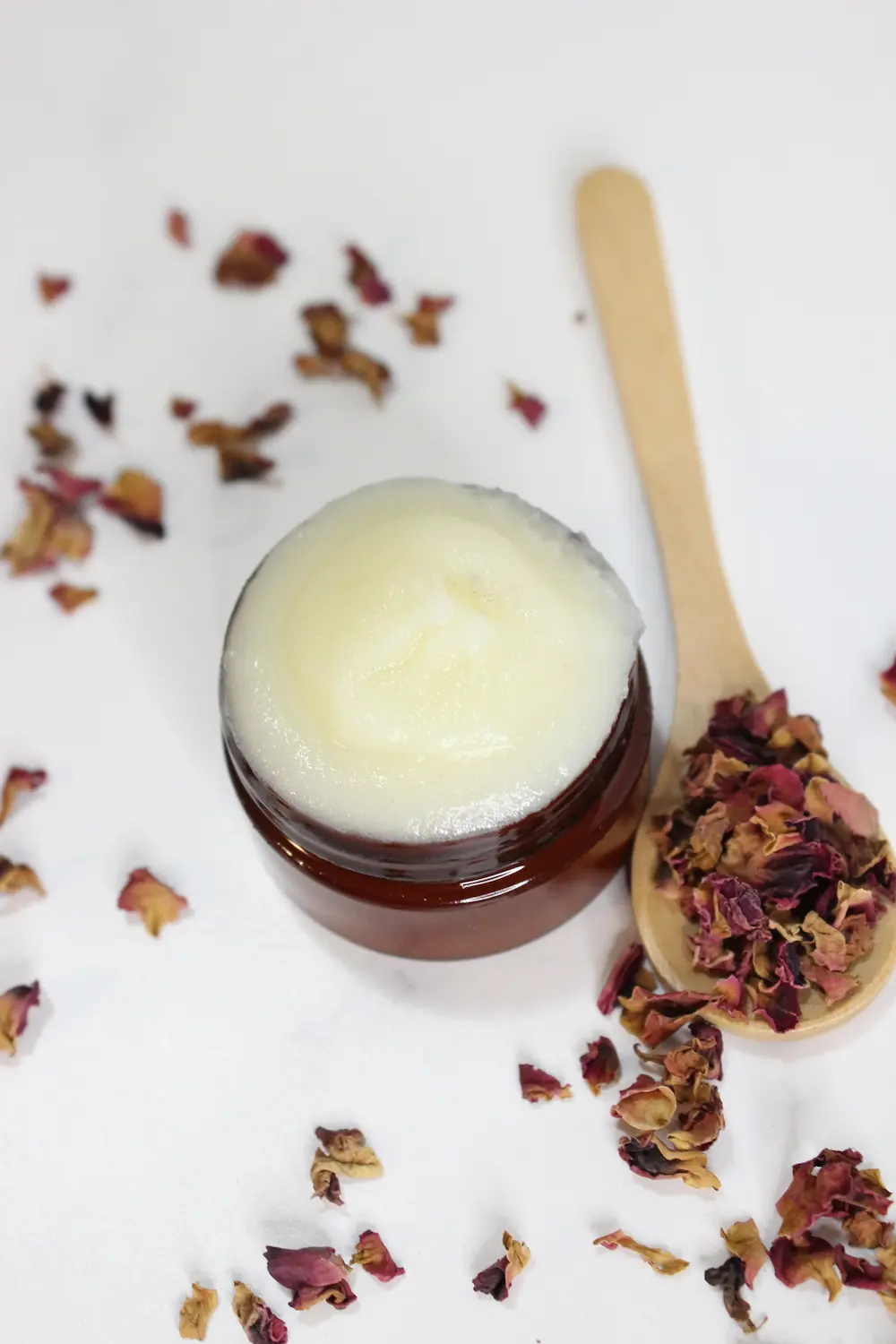 jar of homemade rose tallow face cream with dried roses