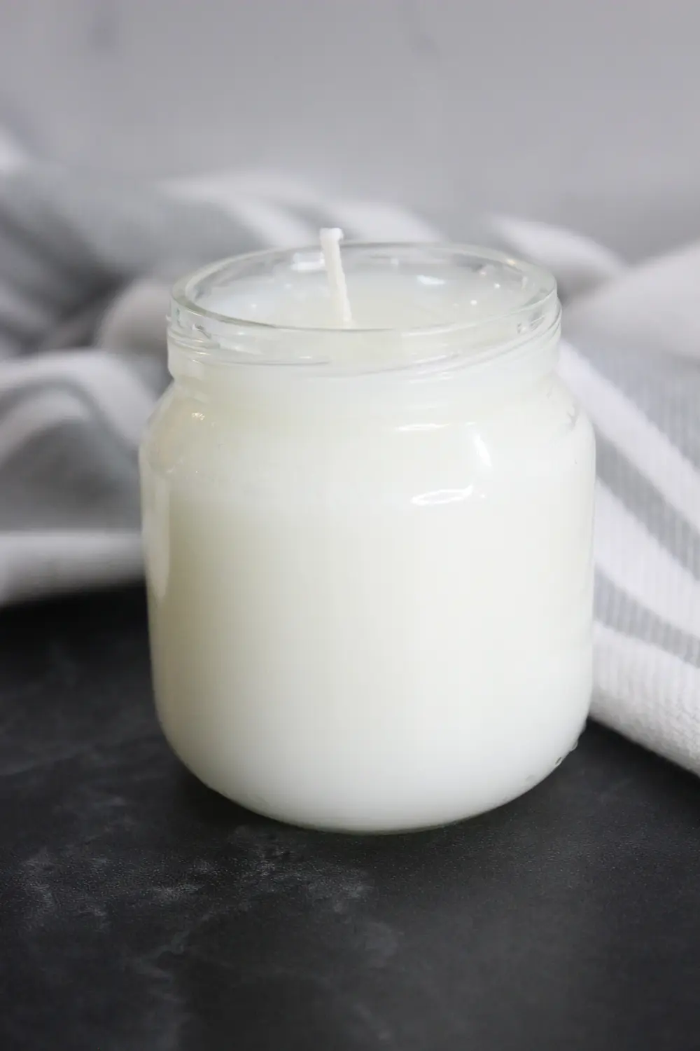 glass jar of a homemade tallow candle
