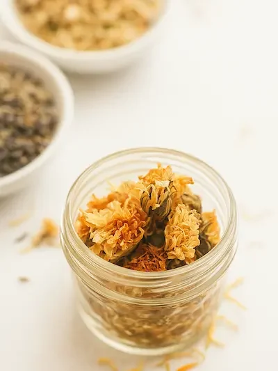 glass jar of dried calendula flowers