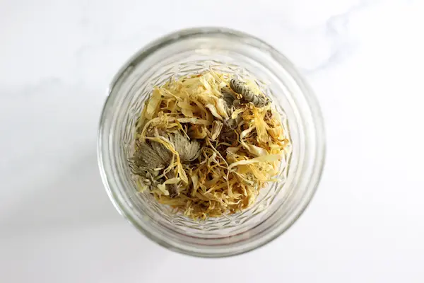 top view of a jar containing dried calendula flowers