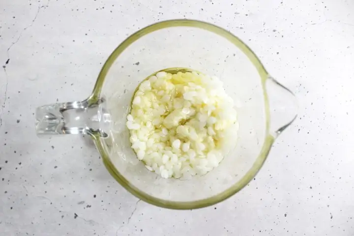 Moisturizing Rose Lotion Bars DIY Recipe 18 oils and wax in a glass measuring cup to make diy rose lotion bars