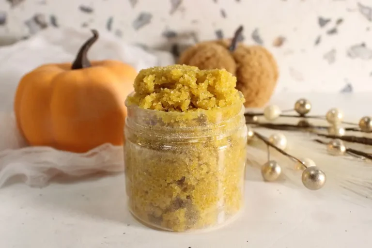 jar of homemade pumpkin spice sugar scrub with a pumpkin in the background