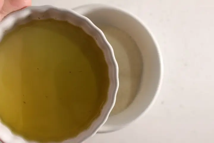 a bowl of  carrier oil and a bowl of sugar for making sugar scrub