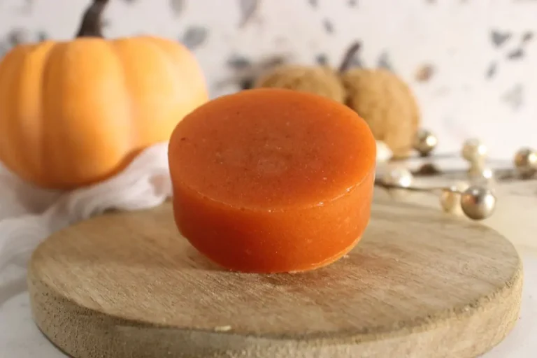 homemade bar of pumpkin spice soap on a wooden board