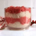 jar of homemade candy cane sugar scrub with red and white layers