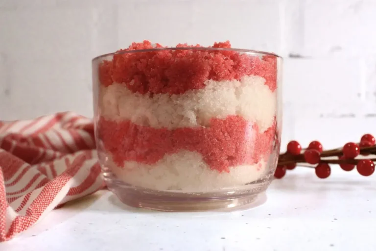 jar of homemade candy cane sugar scrub with red and white layers