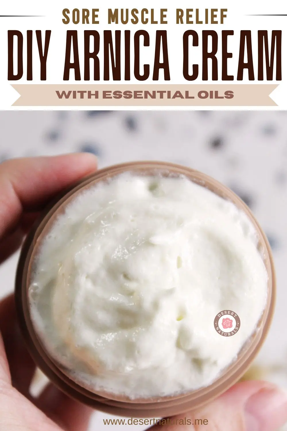 hand holding a jar of homemade arnica cream for sore muscles