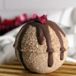homemade chocolate rose bath bomb on wooden pedestal