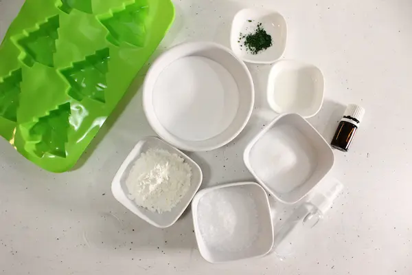 Charming Christmas Tree Bath Bombs Recipe 13 bowls of ingredients and supplies needed to make Christmas Tree Bath Bombs