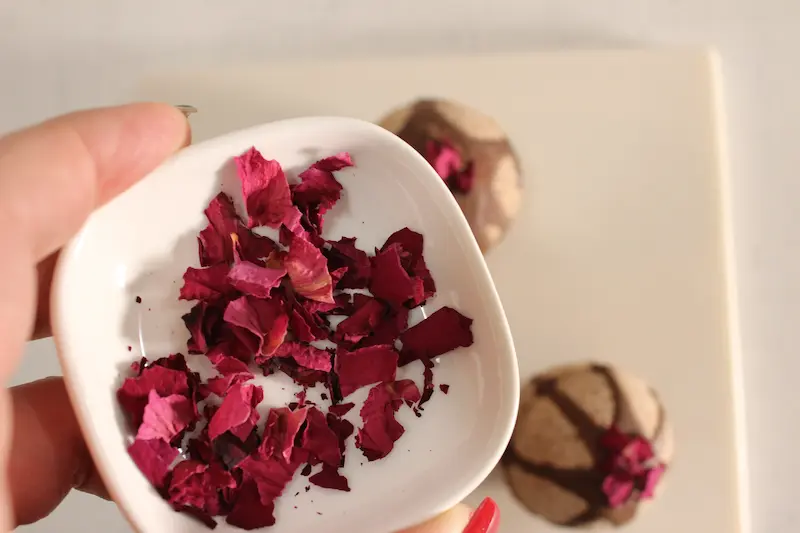 Rose Chocolate Bath Bomb Recipe 26 a bowl of dried rose petals with chocolate bath bombs in the background