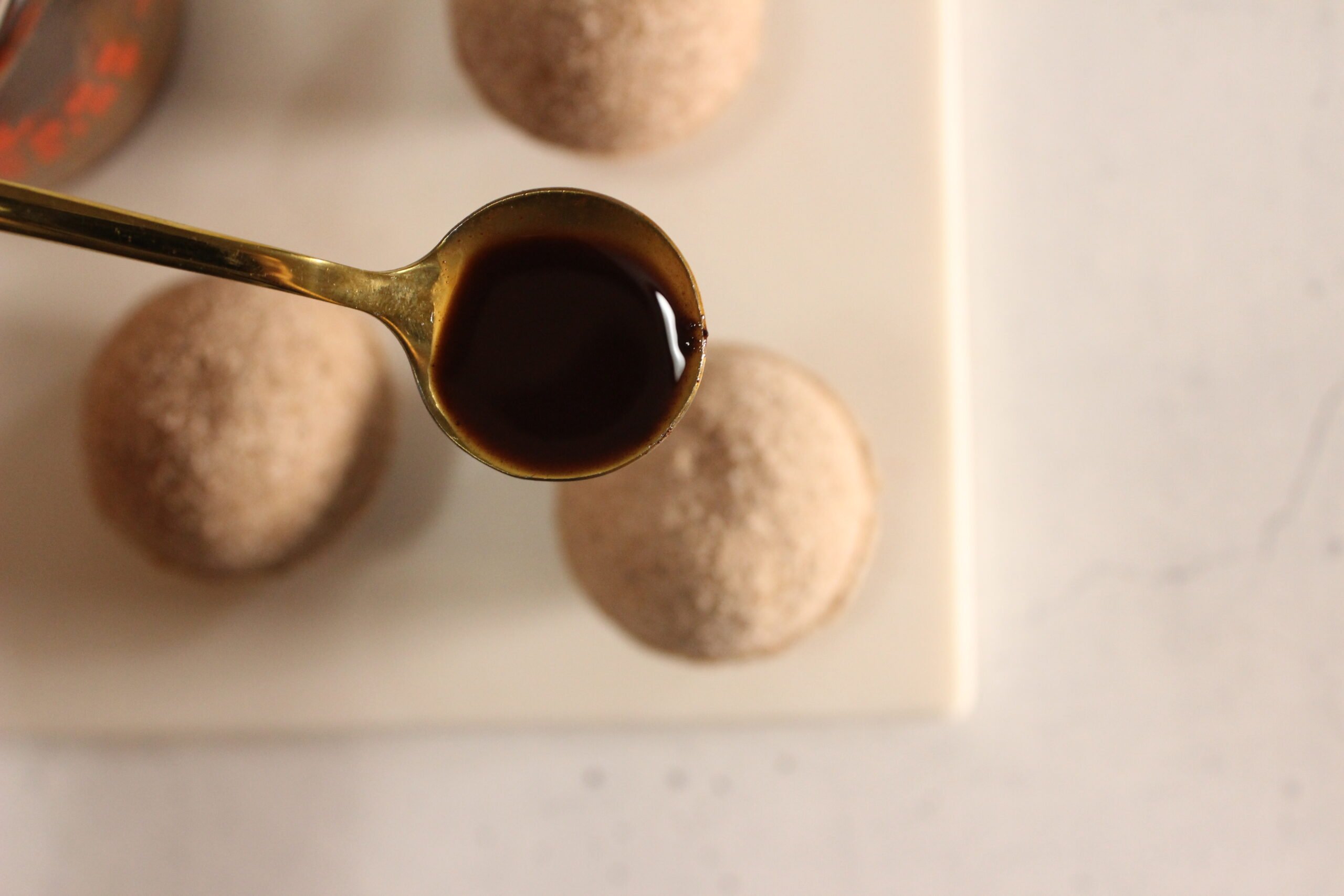 Rose Chocolate Bath Bomb Recipe 25 a spoon drizzling melted cocoa butter over chocolate bath bombs