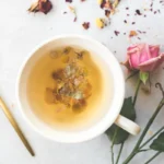 a pretty mug of tea for sleep with a gold spoon with florals
