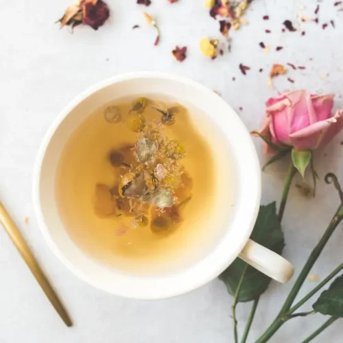 Calming Bedtime Tea Recipes For Sleep 24 a pretty mug of tea for sleep with a gold spoon with florals