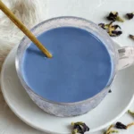 glass teacup of blue moon milk made from butterfly pea flower