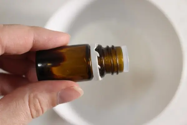 DIY Rice Face Mask for Glass Skin 23 a bottle of essential oil over a bowl of diy rice face mask