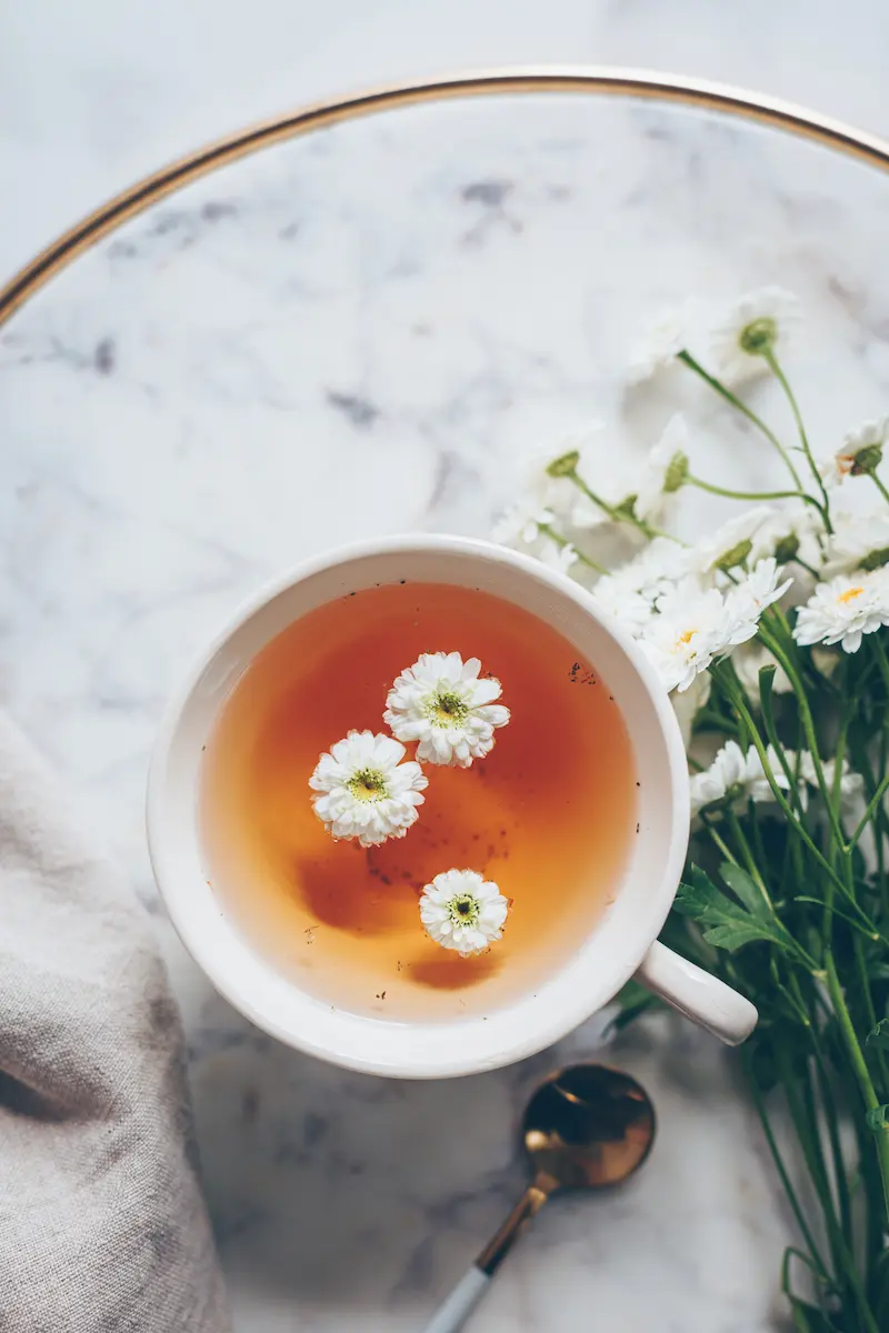 Calming Bedtime Tea Recipes For Sleep 14 a bowl of chamomile tea for sleep with chamomile flowers