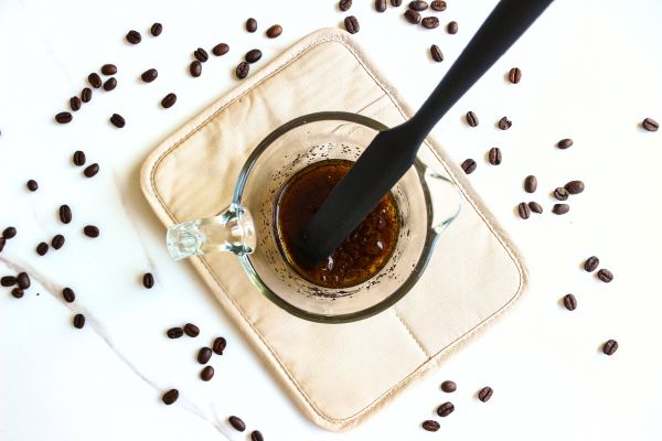 Under Eye Coffee Patches DIY Recipe 20 a bowl of coffee mixture with a spatula in it for making diy coffee eye patches