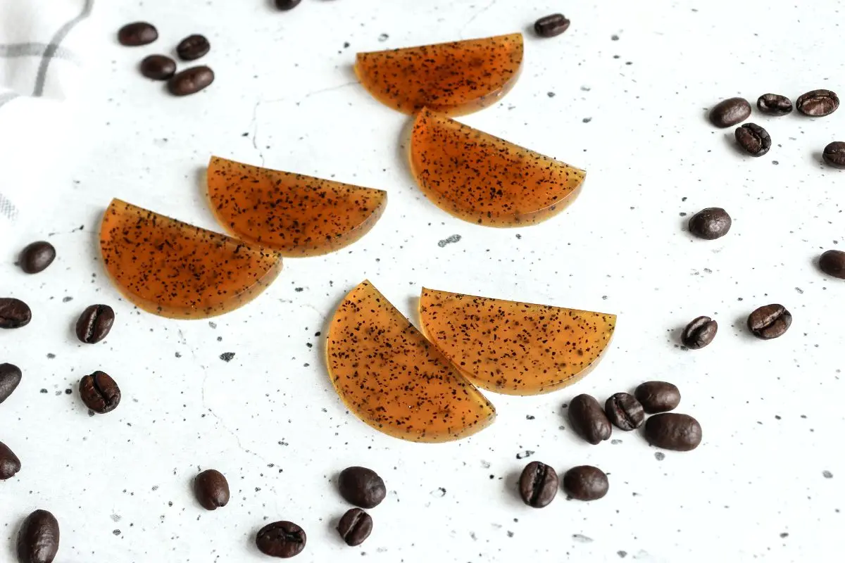 homemade coffee eye patches on a white counter with coffee beans scattered around