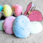 homemade easter bunny bath bombs with Easter eggs decorations in the background