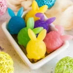 a bowl full of colorful homemade easter bunny soaps