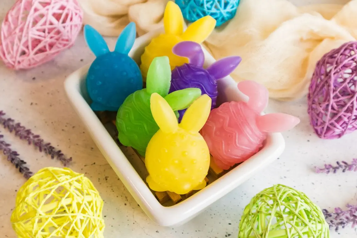 a bowl full of colorful homemade easter bunny soaps