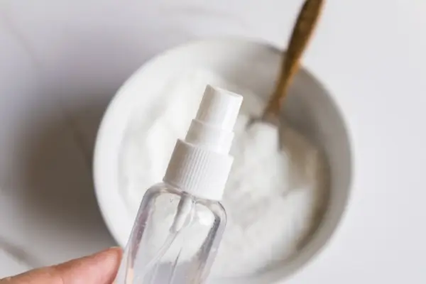 Easter Egg Bath Bombs Recipe 17 a bowl of easter egg bath bomb mixture being sprayed with a small water sprayer