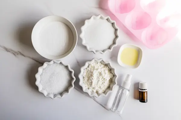 Easter Egg Bath Bombs Recipe 9 bowls of ingredients and supplies needed to make easter egg bath bombs