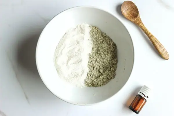 Lavender Tallow Oatmeal Face Scrub Recipe 16 a mixing bowl and wooden spoon with mixture in it to make lavender tallow face scrub