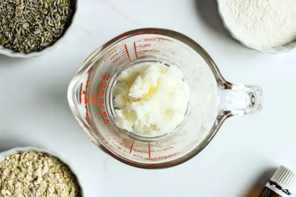 Lavender Tallow Oatmeal Face Scrub Recipe 18 a glass measuring cup with tallow in it