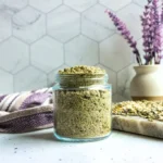 jar of homemade lavender tallow oatmeal scrub with lavender in the background
