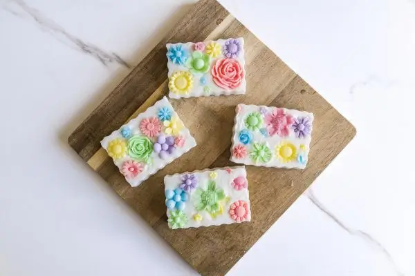 DIY Floral Soap Bars - an impressive handmade gift 38 wooden cutting board with homemade floral soaps on it with wavy edges