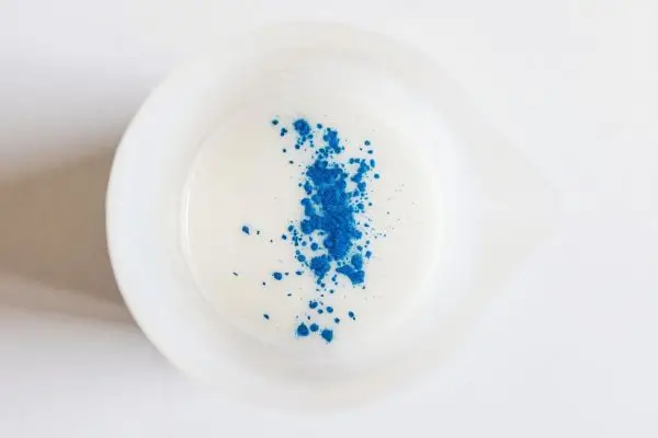 DIY Floral Soap Bars - an impressive handmade gift 26 a bowl of melted soap base with blue mica powder sprinkled into it