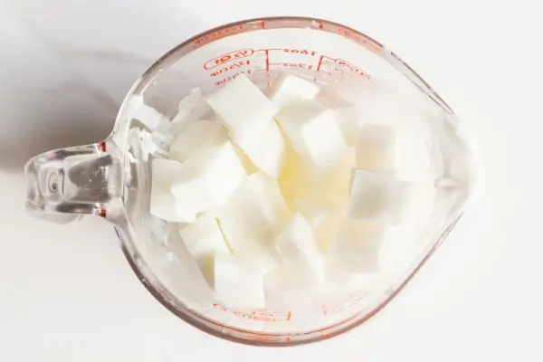 DIY Floral Soap Bars - an impressive handmade gift 30 a glass measuring cup filled with cubes of white melt and pour soap base